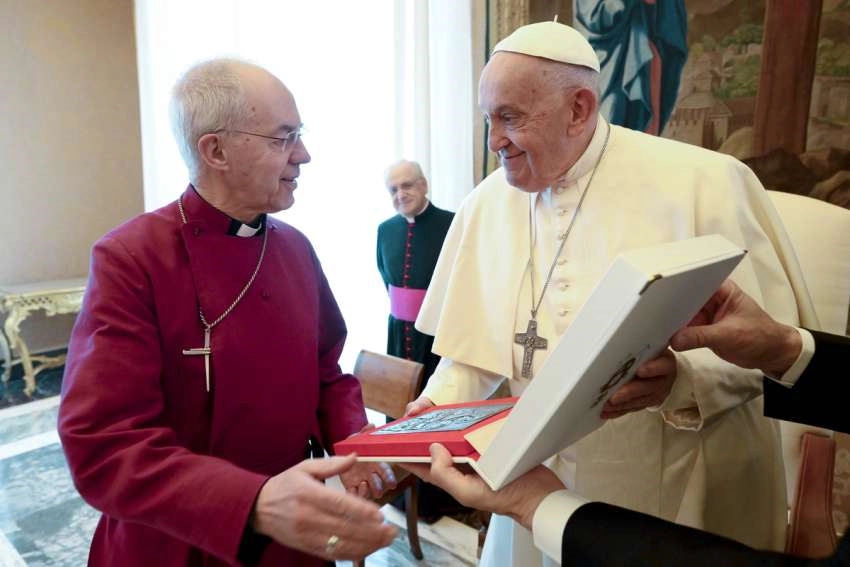 Pope Francis gives a gift to Anglican Archbishop Justin Welby of Canterbury during a meeting with Anglican primates in the Apostolic Palace at the Vatican. The Pope's gift to Archbishop Welby was a bronze icon of the Mother of God, in the style of the image in Santa Maria Maggiore before which Pope Francis prays before and after all his trips, Maria Salus Populi Romani