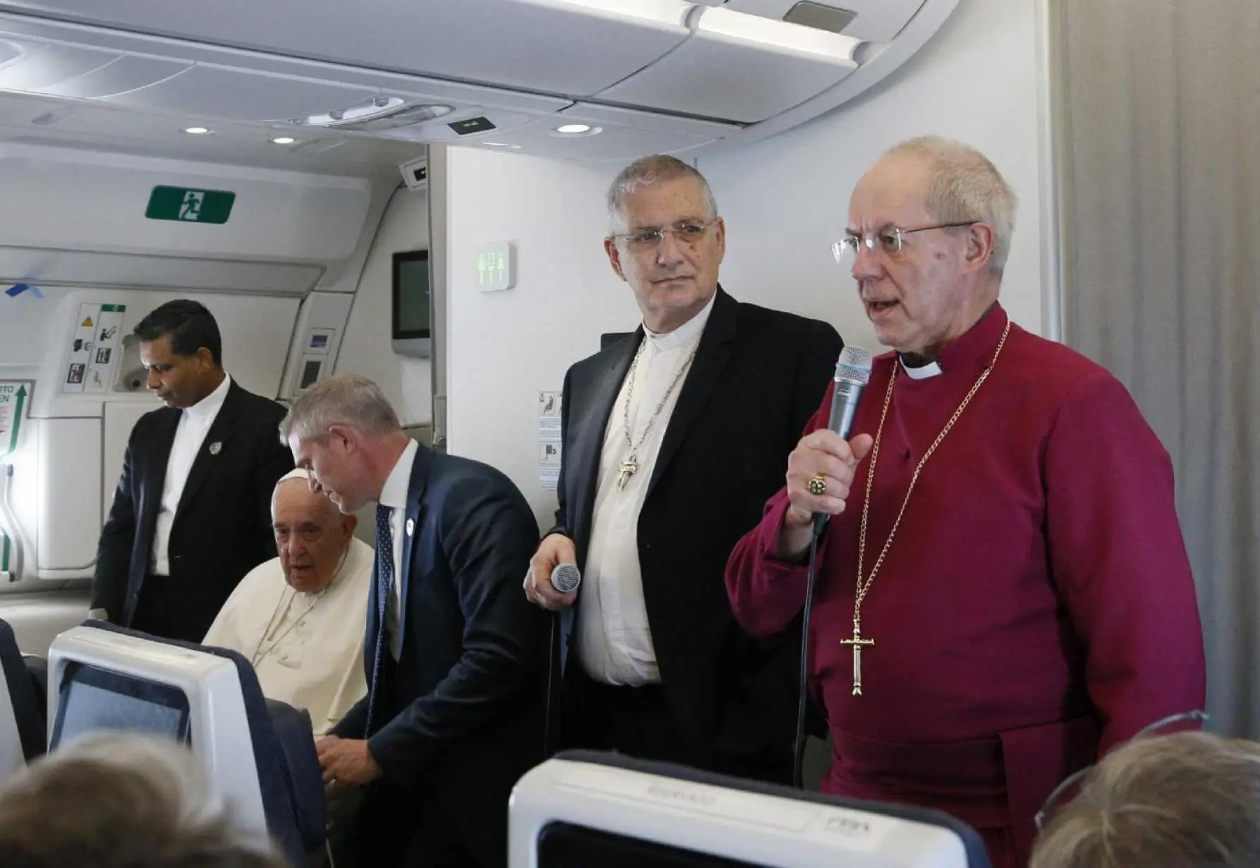 Anglican Archbishop Justin Welby, right, stands by Rev. Iain Greenshields, moderator of the Church of Scotland, and Pope Francis as he speaks to journalists aboard the flight from Juba, South Sudan, to Rome