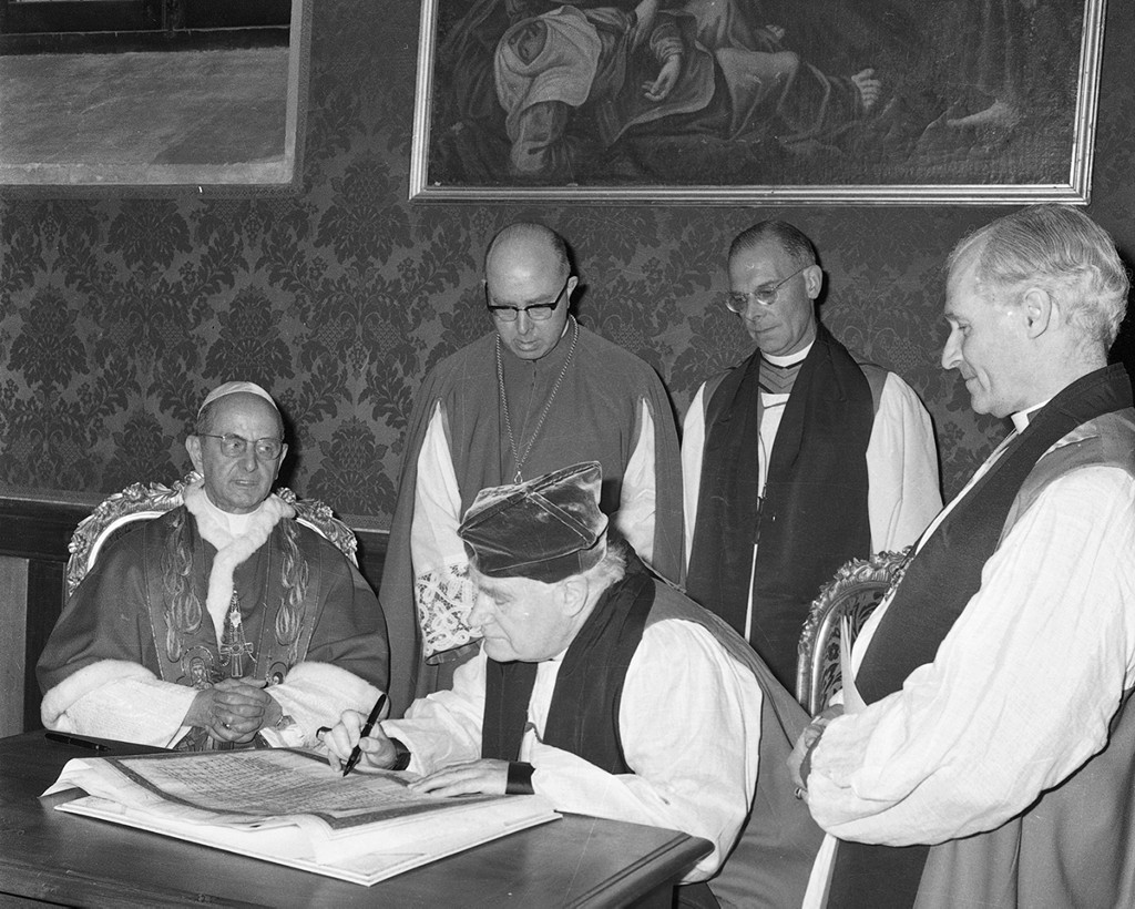 Pope Paul VI (left) and Archbishop Michael Ramsey of Canterbury (centre) signed a common declaration during the Archbishop's visit to Rome