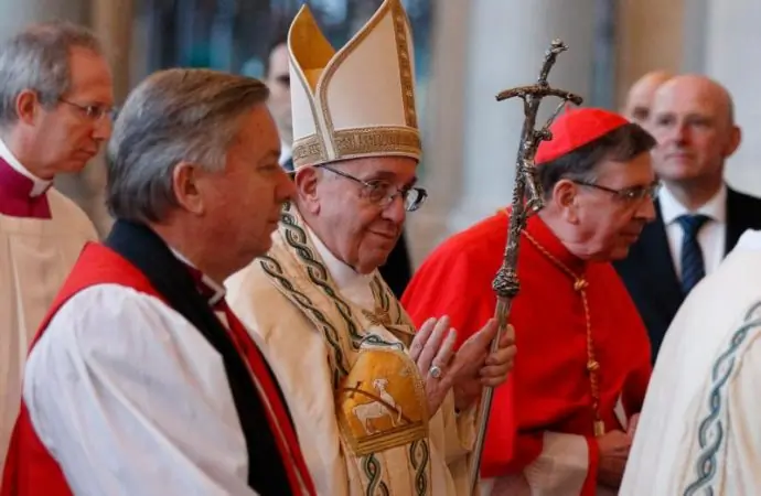 In this 2017 file photo, Pope Francis is flanked by Archbishop David Moxon, then the archbishop of Canterbury's representative to the Vatican, and Cardinal Kurt Koch, president of the Pontifical Council for Promoting Christian Unity, as they arrive for an ecumenical prayer service to conclude the Week of Prayer for Christian Unity at the Basilica of St. Paul Outside the Walls in Rome