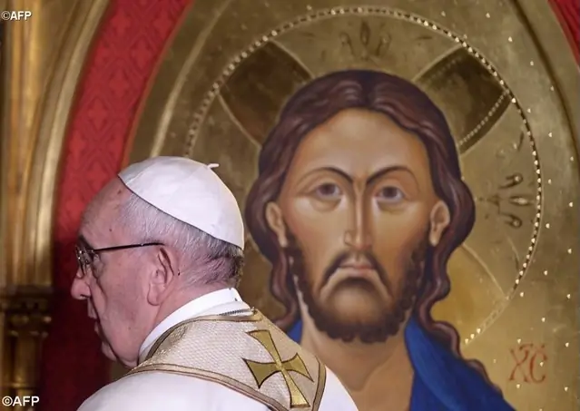 Pope Francis passes in front of an icon of Jesus Christ during his visit at the All Saints' Anglican Church in Rome