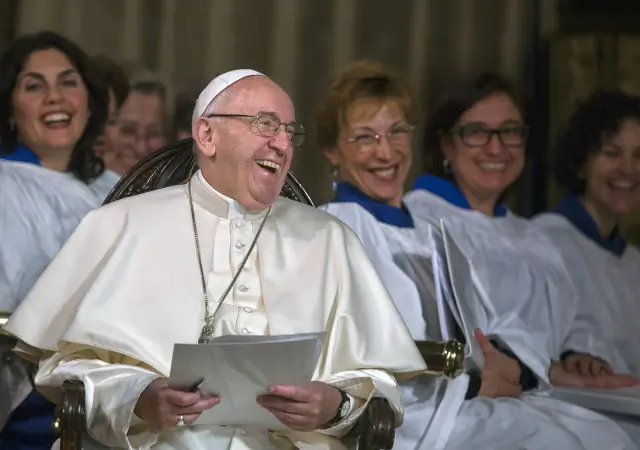 Pope Francis laughs during an evening prayer service at All Saints' Anglican Church in Rome Feb. 26. It was the first time a pope has visited an Anglican place of worship in Rome