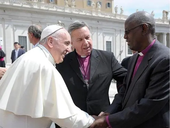 Pope Francis greets Anglican Archbishop Bernard Ntahoturi, together with the outgoing director of Rome's Anglican Centre, Archbishop David Moxon