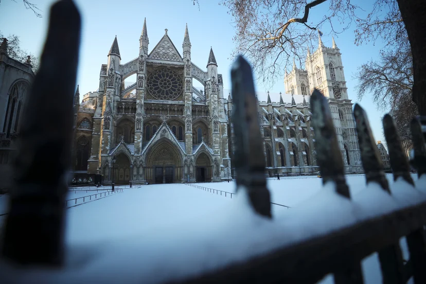 Snow covers the railings outside Westminster Abbey in London
