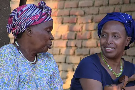 Mathilde Nkwirikiye (right) chats with the grandmother of one of the recipients of a St Timothy Scholarship