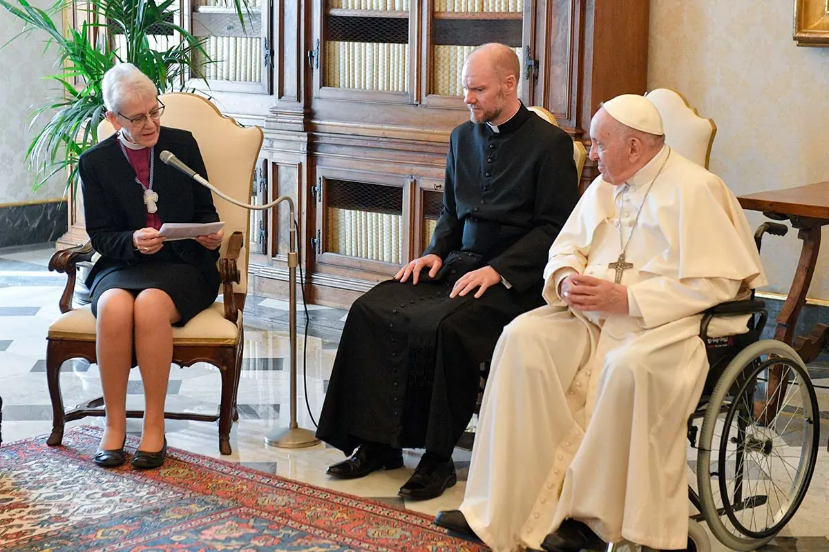 Anglican Archbishop Linda Nicholls, the Anglican primate of Canada and acting co-chair of the Anglican-Roman Catholic International Commission, speaks to Pope Francis during a meeting in the library of the Apostolic Palace at the Vatican