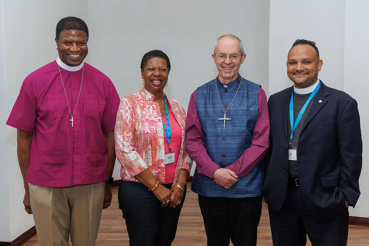 The Episcopal Church’s delegation to the 18th Anglican Consultative Council — Maryland Bishop Eugene Sutton, Annette Buchanan, a lay leader from the Diocese of New Jersey, and the Rev. Ranjit Mathews, the Diocese of Connecticut’s canon for mission, advocacy, racial justice and reconciliation — poses with Archbishop of Canterbury Justin Welby in Accra, Ghana