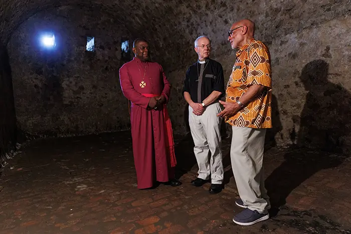The Archbishop of Canterbury Justin Welby in conversation with the Archbishop of Ghana and Primate of West Africa, Archbishop Cyril Ben-Smith (l) and the Bishop of Jamaica and Primate of the West Indies, Archbishop Howard Gregory (r), in a dungeon at the Cape Coast Castle, a former trans-Atlantic slave trading post
