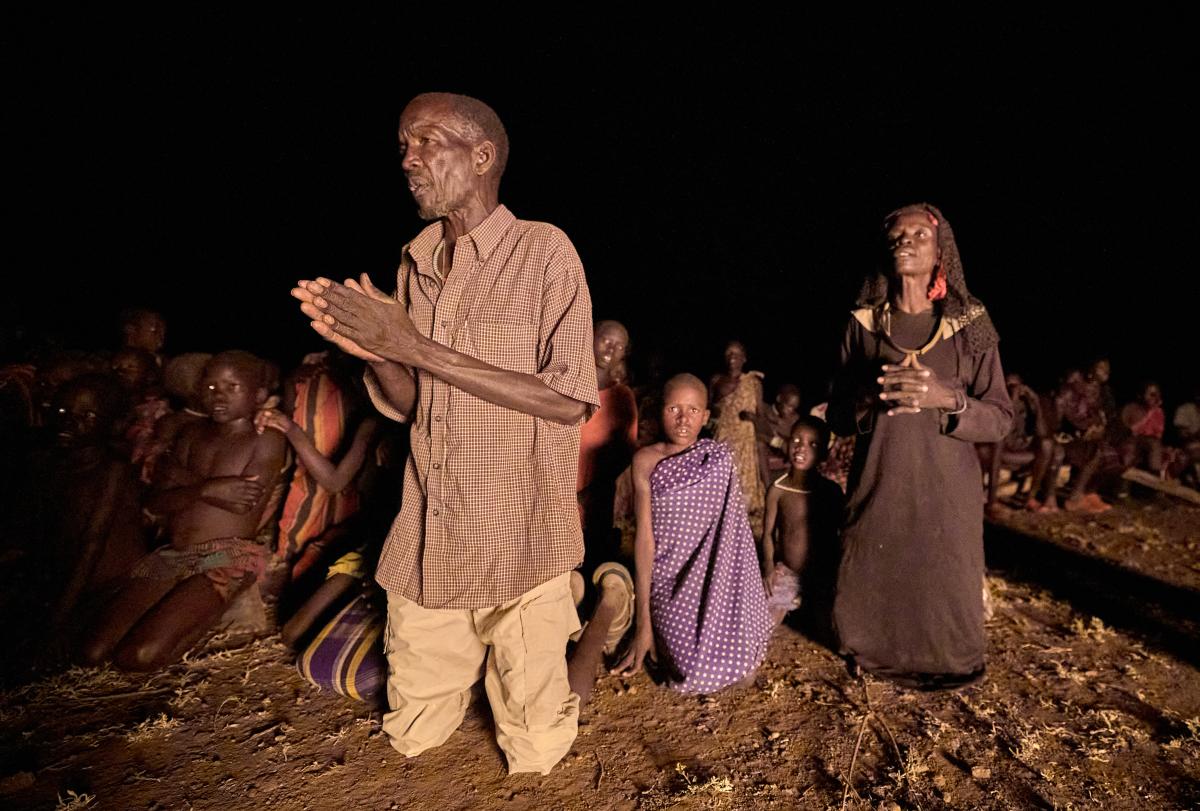 People pray during a nighttime vigil for peace in Nakubuse, a small village near Kuron in South Sudan's Eastern Equatoria State. The region has been plagued by cattle raiding and child abduction in recent years. The Catholic Church-sponsored Holy Trinity Peace Village, centered in Kuron, has worked for years to foster reconciliation and peace between the region's pastoralist communities