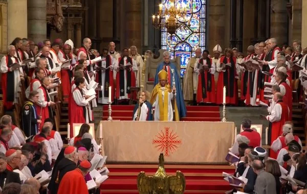 A view of the sanctuary during the installation of the new Archbishop of Canterbury, Sarah Mullally. Ecumenical and interreligious guests are seated at the lower left and right of the photo. The new archbishop is surrounded by primates, archbishops, and bishops from around the Anglican Communion
