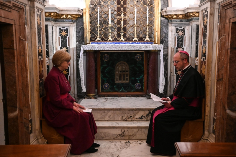 Archbishop of Canterbury Sarah Mullally sits with Bishop Flavio Pace at the tomb of St Paul inside the Basilica of St Paul Outside the Walls