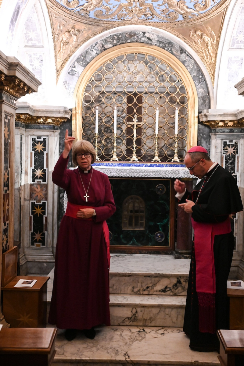 Archbishop of Canterbury Sarah Mullally offers a blessing during prayer with Bishop Flavio Pace at the tomb of St Paul inside the Basilica of St Paul Outside the Walls