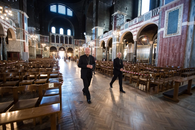 Cardinal Vincent Nichols and Archbishop Justin Welby walk down the aisle of Westminster Cathedral