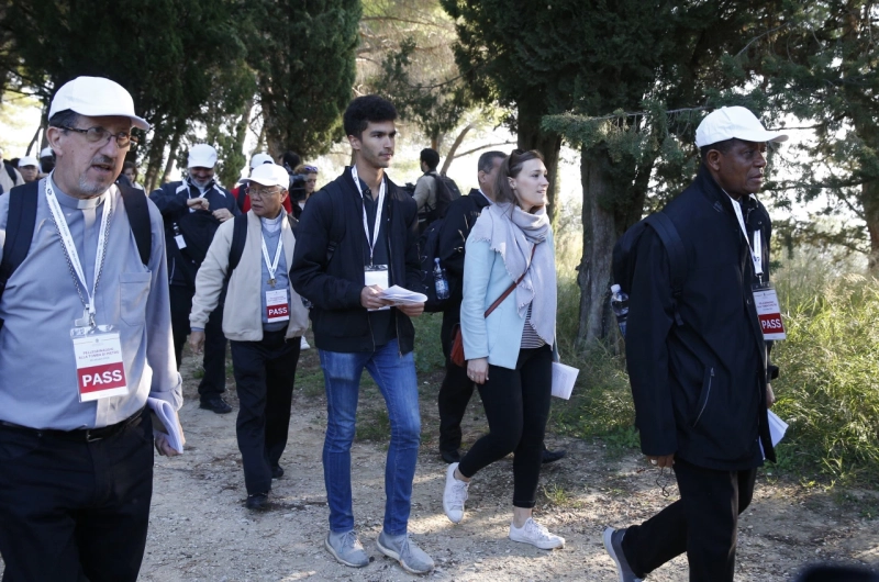 Sebastian Duhau, a synod observer from Australia, and Emilie Callan, a synod observer from Canada, participate in a pilgrimage hike from the Monte Mario nature reserve in Rome to St. Peter's Basilica at the Vatican Oct. 25. Cardinal Christoph Schonborn of Vienna said synodality refers to all the baptized taking responsibility for the church and its mission, each according to his or her talents and role within the church