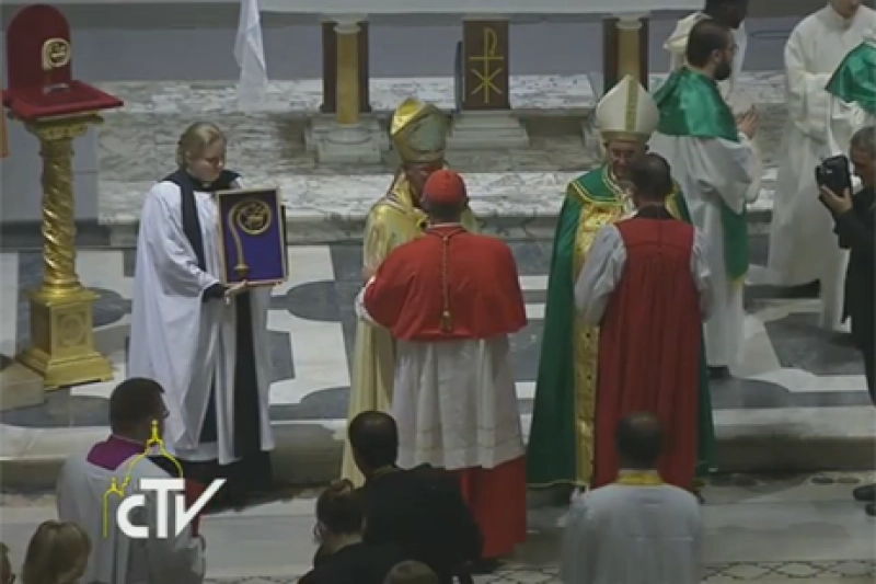 A priest holds the replica of the Crozier of St Gregory the Great - the sixth Century Pope who sent Augustine to evangelise the Anglo-Saxons - as Pope Francis and Archbishop Justin Welby greet pairs of bishops being sent out for joint mission. The actual crozier is on a pedestal in the top left hand corner of the picture