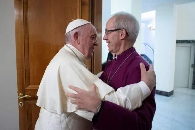 Pope Francis embraces Anglican Archbishop Justin Welby of Canterbury, leader of the Anglican Communion, during a meeting in the pope’s Vatican residence, the Domus Sanctae Marthae