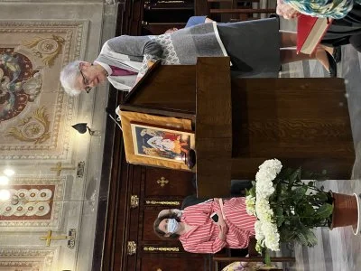 Archbishop Linda Nicholls reads scripture at Caravita