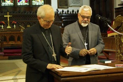 The Roman Catholic Bishop of Saint John, Robert Harris (left), and the Anglican Bishop of Fredericton, David Edwards, sign their joint declaration at St John’s Anglican Church in the New Brunwsick port city of Saint John on Monday