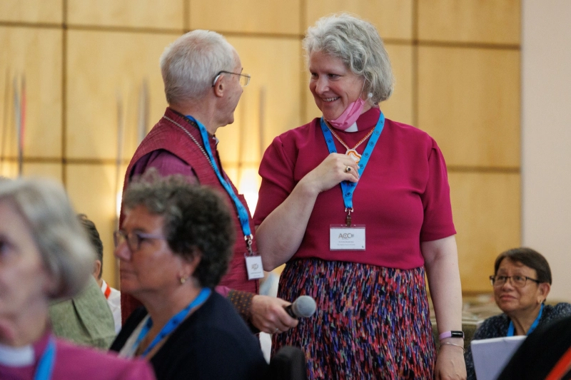Justin Welby, Archbishop of Canterbury, acts as the remote microphone carrier to deliver one to the Rt Rev’d Ryscilla Shaw from the Anglican Church of Canada during Session 4: Standing Committee report & update on progress with ACC-17 resolutions, Secretary General’s update, new Networks and Commissions at the eighteenth Anglican Consultative Council at the Marriott Hotel Accra, Ghana