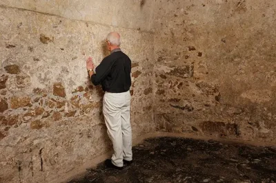 The Archbishop of Canterbury, Justin Welby, takes time out from a tour of Cape Coast Castle with members of ACC-18 for a moment of personal prayer and reflection in a former slave dungeon