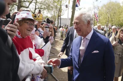 Britain’s King Charles III greets well-wishers outside Buckingham Palace in London a day before his coronation takes place at Westminster Abbey
