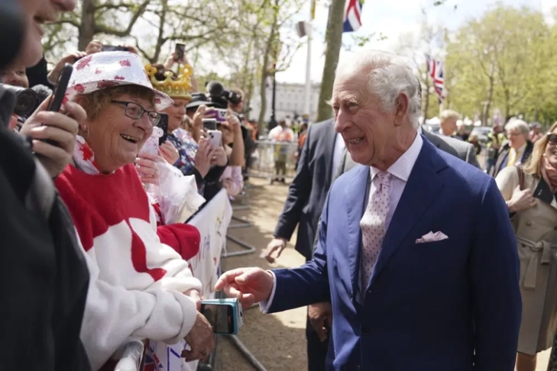 Britain’s King Charles III greets well-wishers outside Buckingham Palace in London a day before his coronation takes place at Westminster Abbey