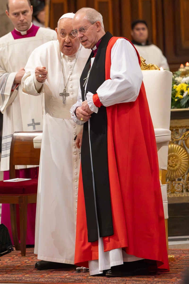 Pope Francis points something out to Anglican Archbishop Justin Welby of Canterbury after an evening prayer service concluding the Week of Prayer for Christian Unity at Rome's Basilica of St Paul Outside the Walls