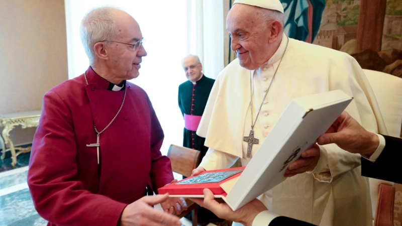 Pope Francis gives a gift to Anglican Archbishop Justin Welby of Canterbury during a meeting with Anglican primates in the Apostolic Palace at the Vatican. The Pope's gift to Archbishop Welby was a bronze icon of the Mother of God, in the style of the image in Santa Maria Maggiore before which Pope Francis prays before and after all his trips, Maria Salus Populi Romani
