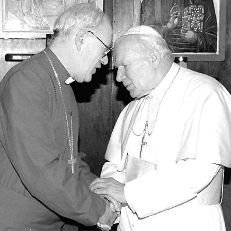 Archbishop of Canterbury George Carey and Pope John Paul II converse in the sacristy of St Gregory's Church in Rome