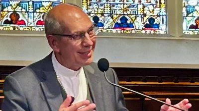 Archbishop Donald Bolen, co-chair of IARCCUM, speaking at Georgetown University during a panel presentation