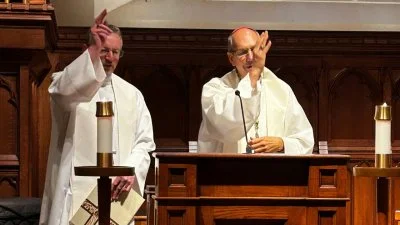 Bishop Robert Innes and Archbishop Donald Bolen, co-chairs of IARCCUM, offer a blessing during prayers at Georgetown Univeristy