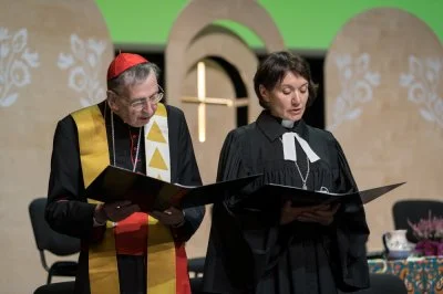 Cardinal Kurt Koch, prefect of the Vatican Dicastery for Promoting Christian Unity, and the Rev. Anne Burghardt, general secretary of the Lutheran World Federation, pray during an ecumenical service at the LWF assembly in Krakow, Poland