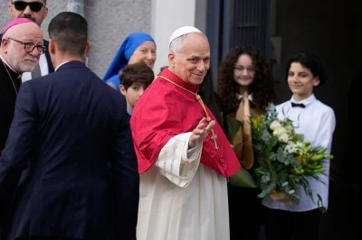 Pope Leo XIV waves to the people as he arrives at the Cathedral of the Holy Spirit in Istanbul during his first foreign trip