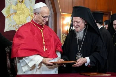 Pope Leo XIV and Ecumenical Patriarch Bartholomew of Constantinople hand each other copies of a joint declaration they signed at the end of a prayer service in the Patriarchal Cathedral of St. George in Istanbul
