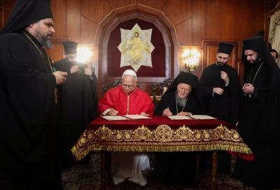 Pope Leo XIV and Ecumenical Patriarch Bartholomew I sign a joint declaration at the Ecumenical Patriarchate during the pope’s first apostolic journey, in Istanbul, Türkiye